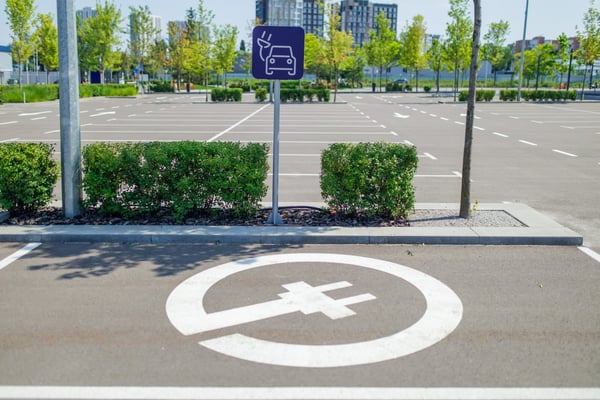 Parking lot EV charging station sign in a large parking lot 629720726